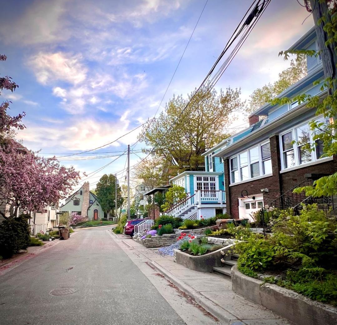 A wide shot of houses along a quiet residential street at dusk